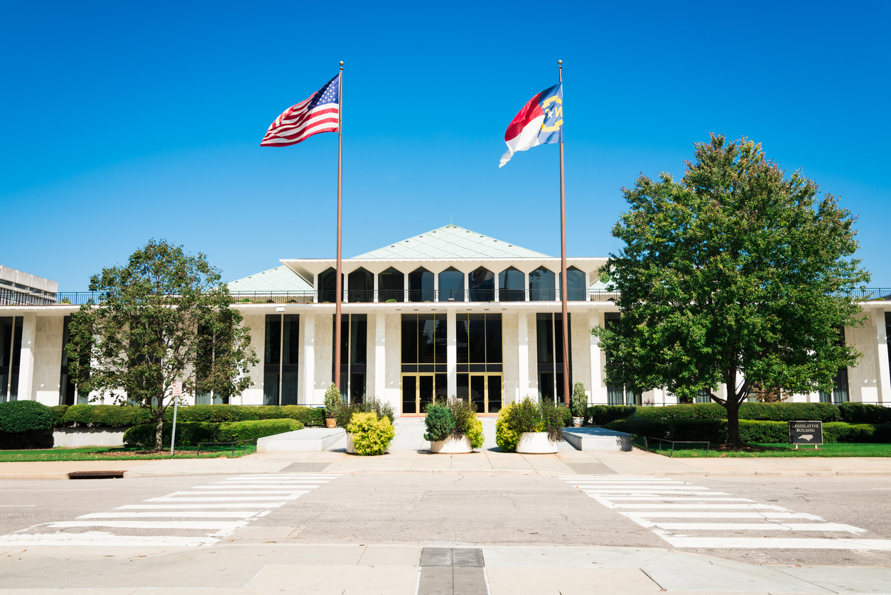 "North Carolina Legislative Building with American and North Carolina Flags in the wind. The North Carolina State Legislative Building is the meeting place of the North Carolina General Assembly, the state legislature of the U.S. state of North Carolina. Raleigh, North Carolina, USA"