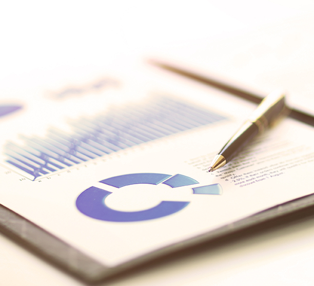 A closeup of a business financial chart with graphs. A pen on top. Represent business expenses, growth or revenue.