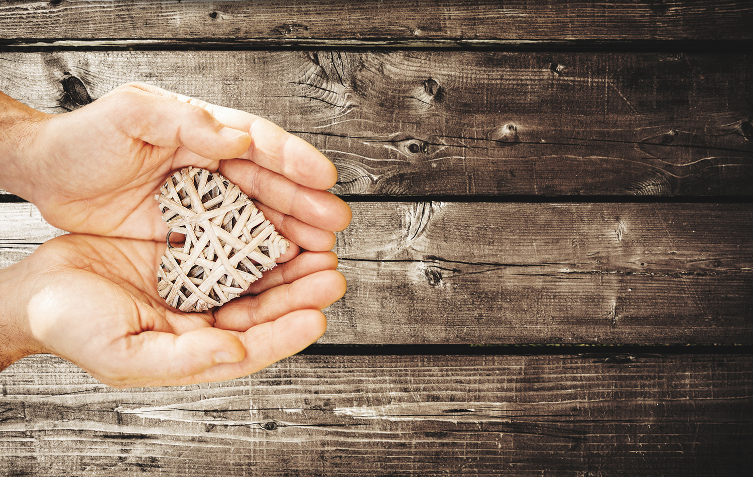 holding an wooden heart for st. valentine